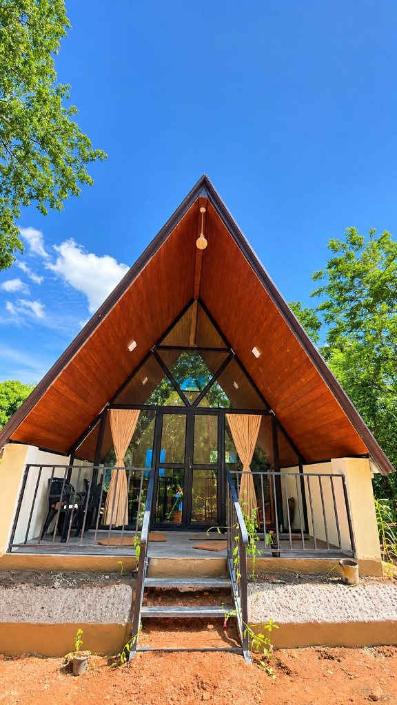 Green Heaven A-frame cabana in bright daylight